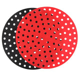 there are two red and black polka dot plates on a white background