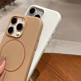 Two silicone phone cases, one tan and one white, with camera cutouts and side buttons.