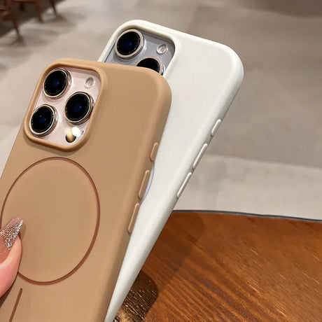 Two silicone phone cases, one tan and one white, with camera cutouts and side buttons.
