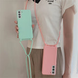 Two silicone smartphone cases with attached lanyards, one mint green and one pink.