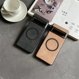 Two sleek, minimalist phone cases with circular camera cutouts in black and tan colors.