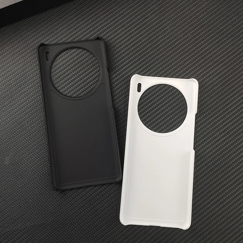 Two smartphone cases, one black and one white, with circular cutouts for the camera.