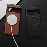 Two smartphone cases with circular cutouts, one burgundy and one black, designed for wireless charging compatibility.