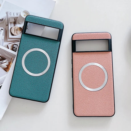 Two smartphone cases with circular designs, one teal and one pink.