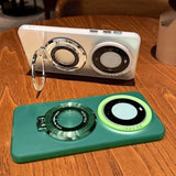 Two smartphone cases with large, circular camera-like designs and integrated kickstands.