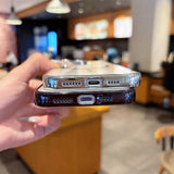Two smartphone cases, one clear with a silver edge and one dark with a black edge, both featuring cutouts for charging ports and speakers.