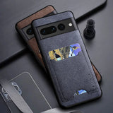 Two smartphone cases, one dark blue and one brown, both with a textured finish and a built-in card holder.
