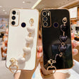 Two smartphone cases with decorative heart-shaped charms attached.