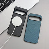 Two smartphone cases with a diagonal stripe pattern, one black and one teal, with a white circular wireless charger attached to the black case.