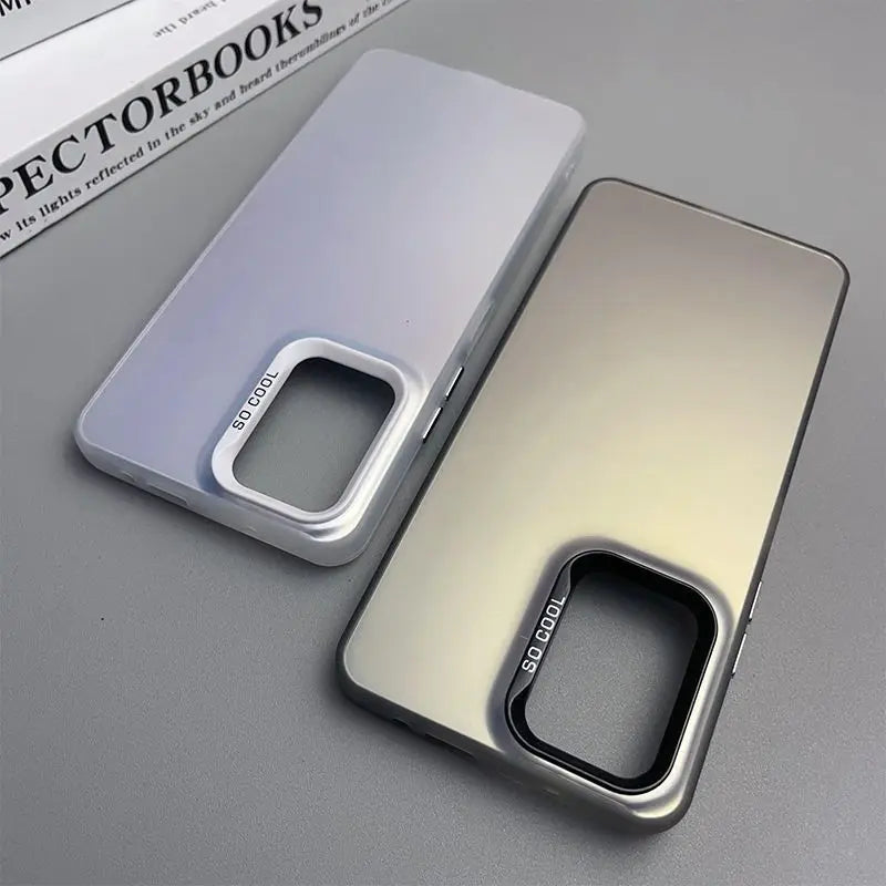 Two smartphone cases with prominent camera cutouts, one in white and one in metallic gold.