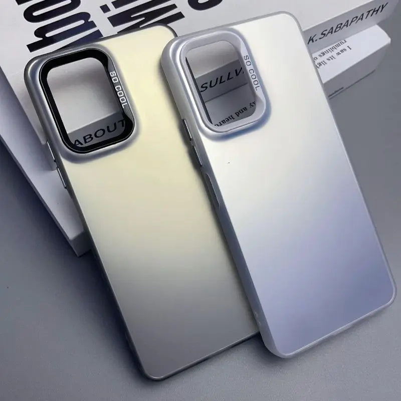 Two smartphone cases, one white and one cream-colored, with prominent camera cutouts.