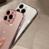 Two smartphones with clear, shiny cases, one pink and one white.