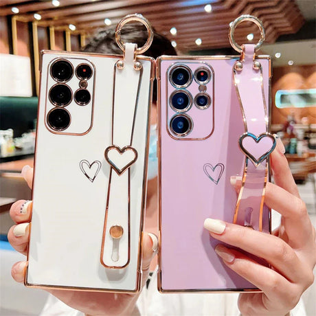 Two smartphones in decorative cases with heart-shaped accents.
