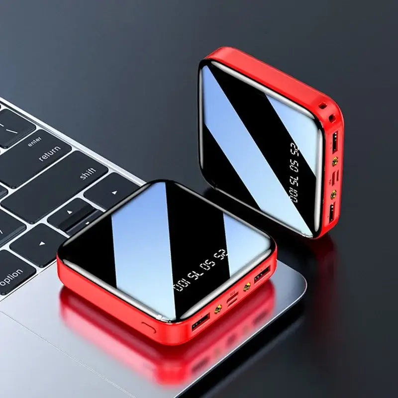 two smartphones with a red case on top