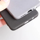 Two textured smartphone cases, one light gray and one dark gray, with precise cutouts for buttons and ports.