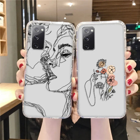Two transparent samsung galaxy phone cases with abstract art design featuring black line faces and pastel flowers on back side