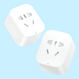 Two white smart electrical outlet adapters with multiple plug sockets.