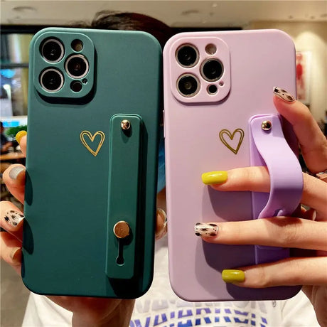 two women holding up their iphone cases