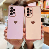 two women holding up their iphones with heart shaped cases