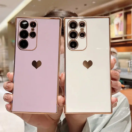 Two women holding up their iphones with hearts on them