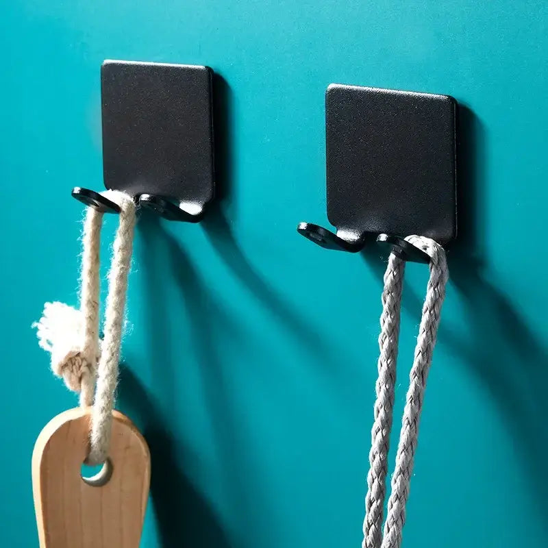 two wooden hooks hanging on a wall