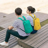 two young people sitting on a bench and talking