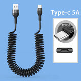 a black coiled cable connected to a white phone