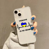 a woman holding a phone case with the words ukraine in my heart
