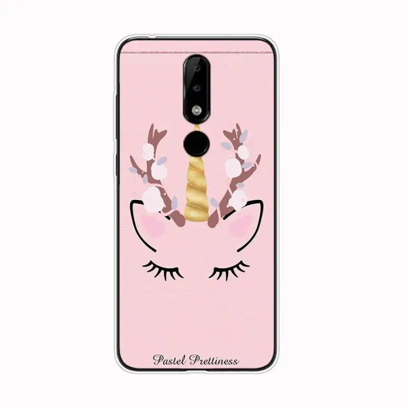 a pink phone case with a unicorn face and eyelashes
