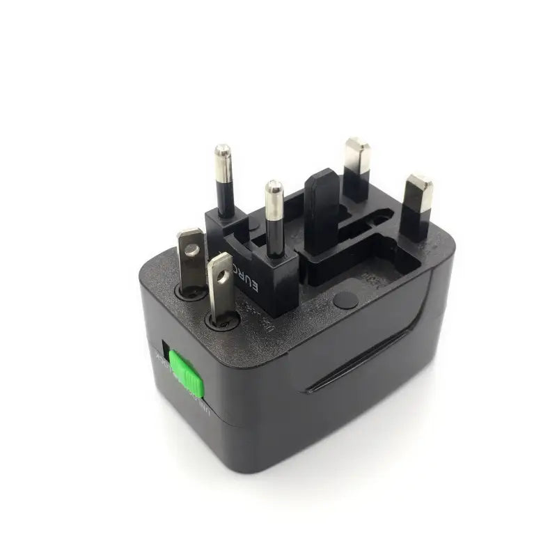 a black power adapt with two green plugs