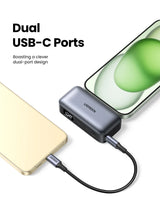 USB-C hub or adapter with dual ports connected to devices.