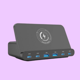 USB hub or docking station with multiple ports and a wireless charging symbol on top.