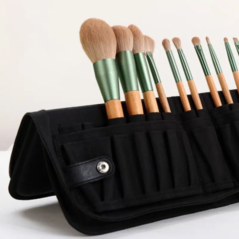 a black bag with a set of brushes in it
