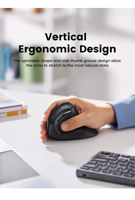 Vertical ergonomic computer mouse being used by a hand on a desk.