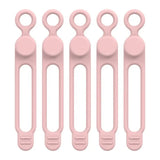 six pink plastic spoons with handles and handles on a white background