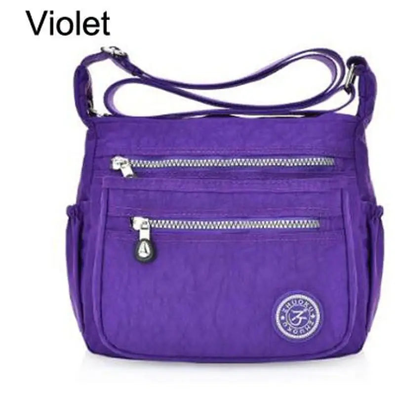 a close up of a purple purse with a zipper on the front