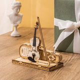 a violin and a gift box on a table