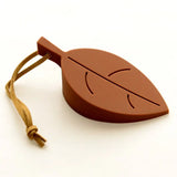 a chocolate leaf shaped object with a string around it