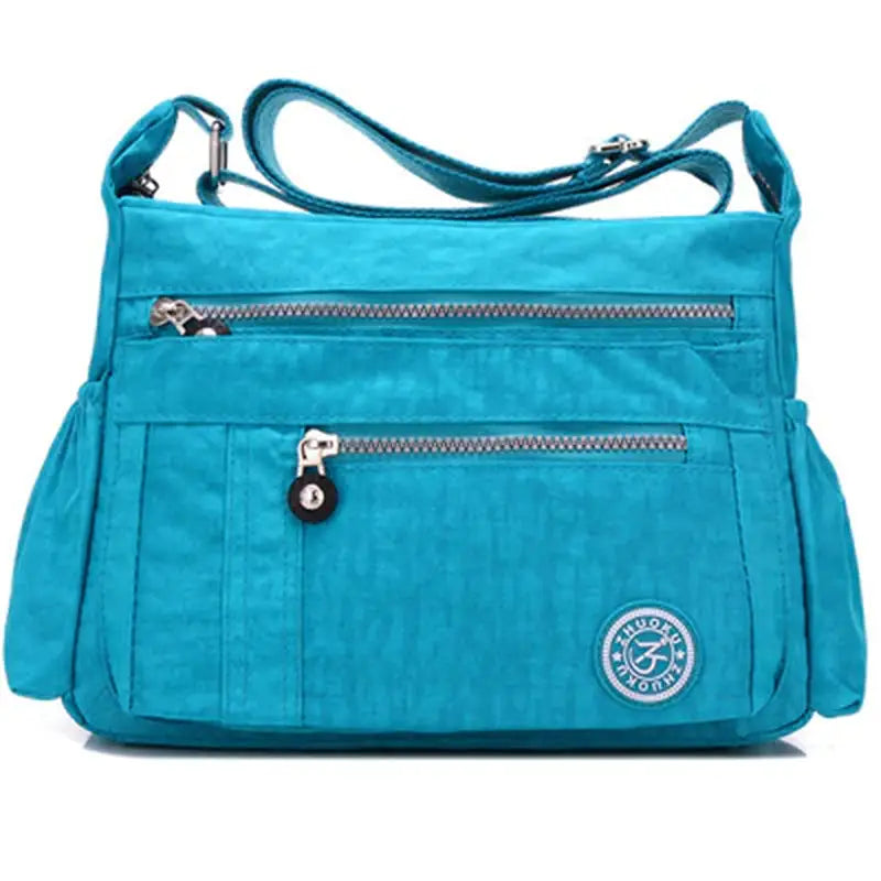 a blue purse with a zipper and a zippered pocket