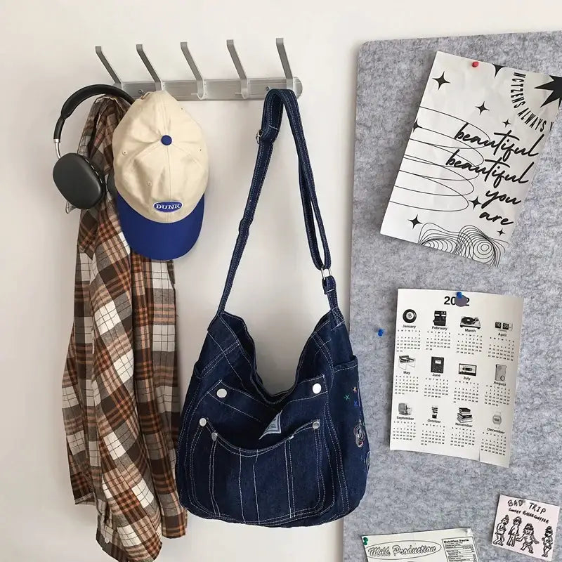 a wall mounted coat rack with a hat and scarf