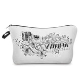 a white cosmetic bag with a black and white drawing of a piano, piano, and flowers