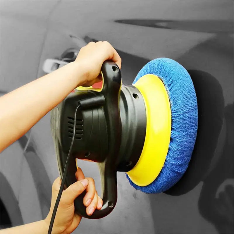 a person using a sponge to clean the car