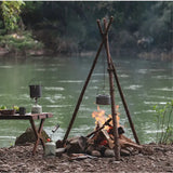 a campfire with a pot and a pot on it