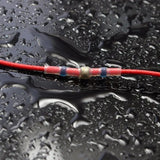 a red and black cable connected to a black car