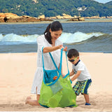 a woman and child playing on the beach