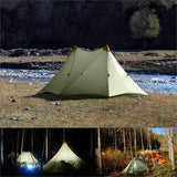 a tent with a light on it and a river in the background