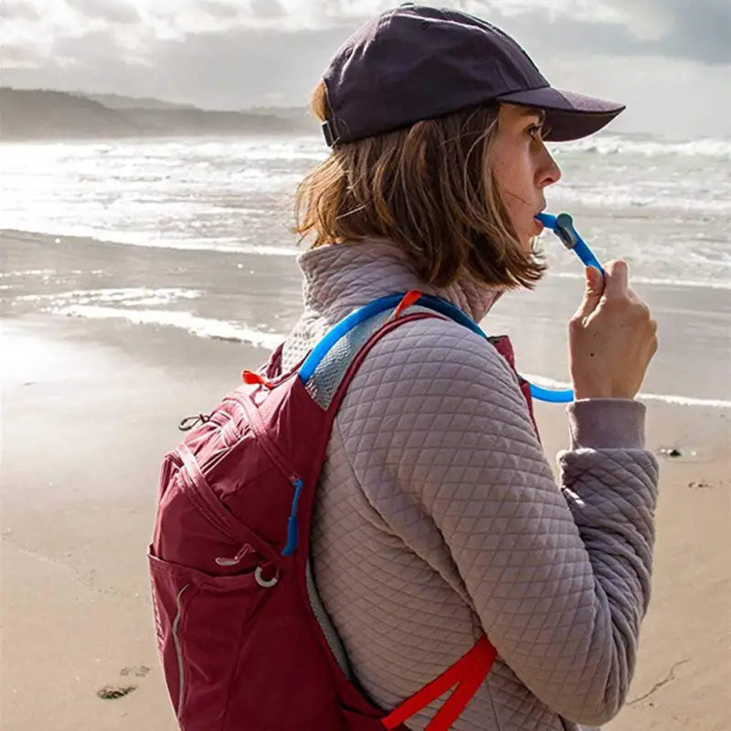 a woman with a backpack on the beach