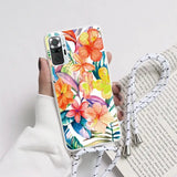 a woman holding a phone case with a colorful floral design