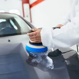 a man waxing a car with a brush