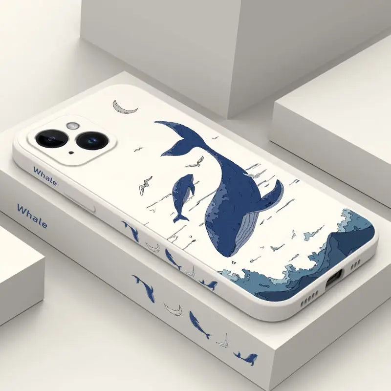 a phone case with a whale and fish design